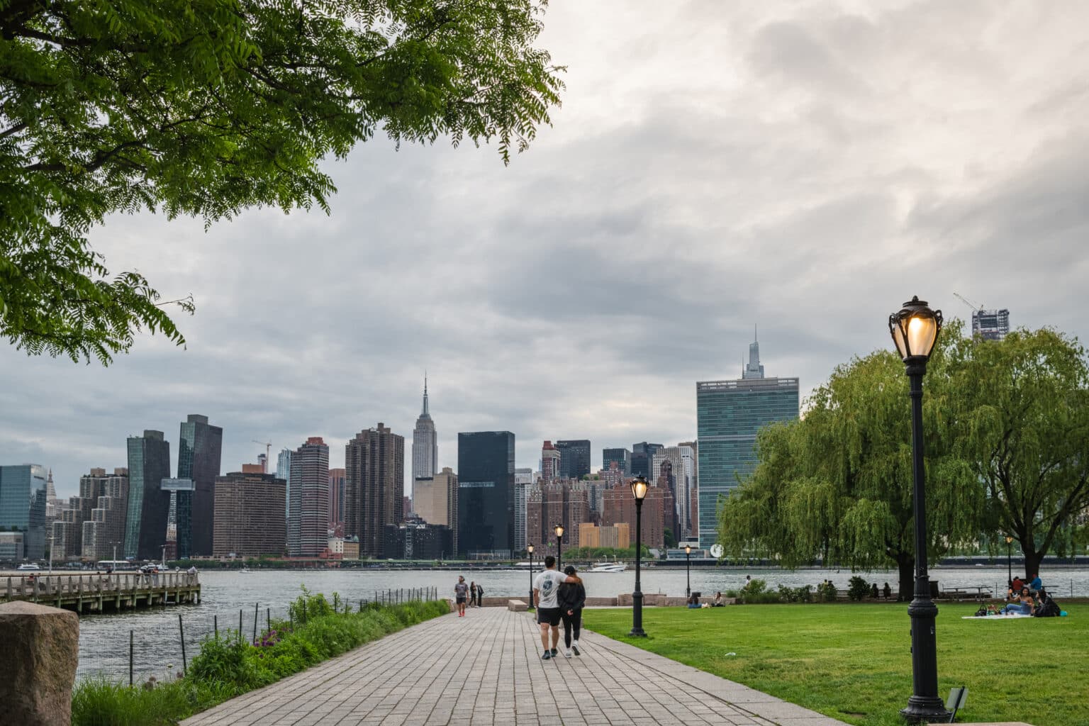 Manhattan skyline against a cloudy sky as seen from Gantry Plaza State Park