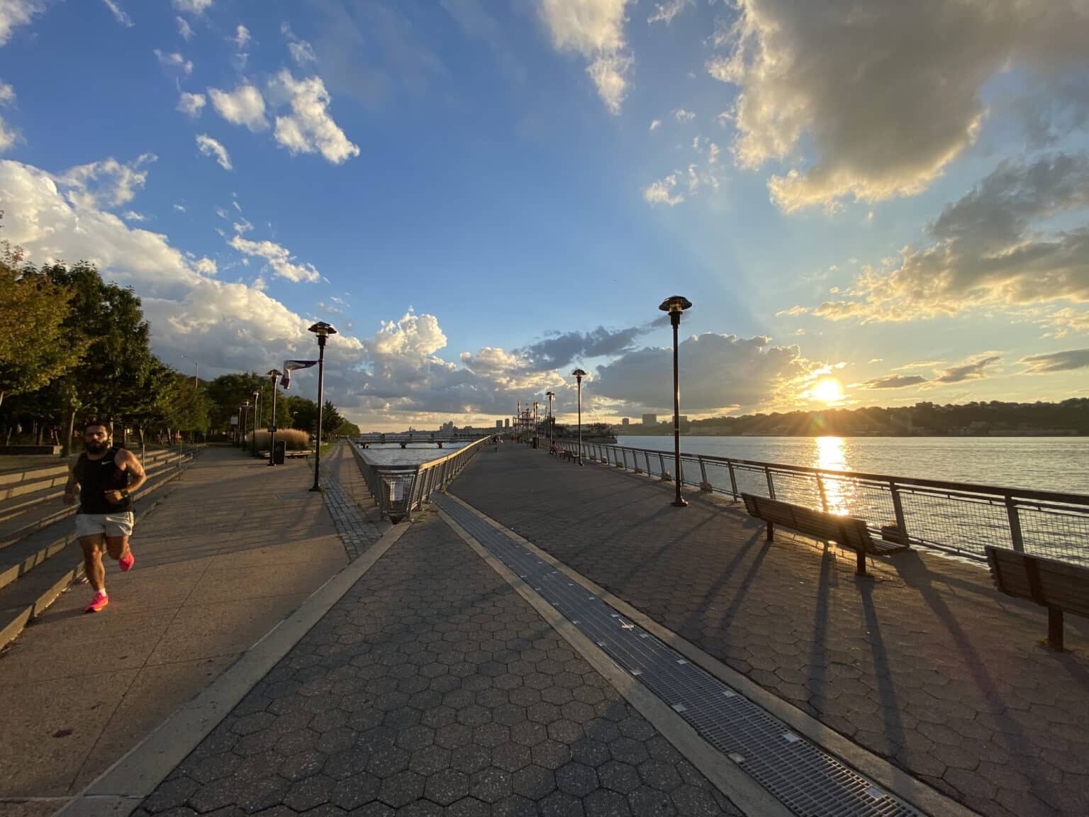 Man jogging on a trail by the Hudson River on a summer evening in New York City