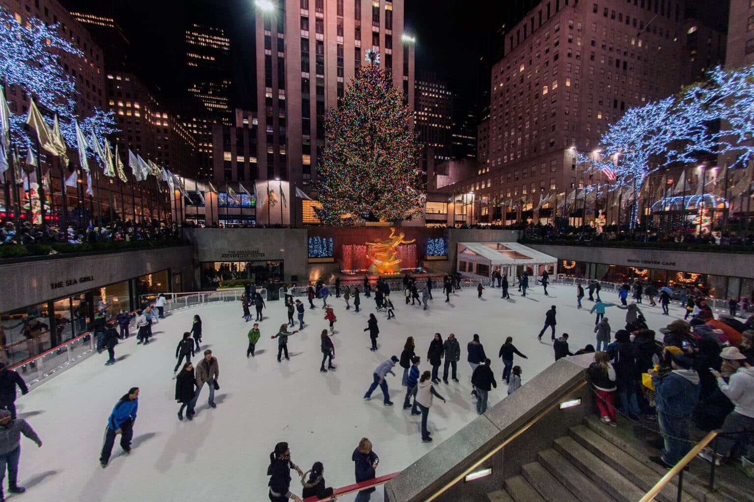People skating at rockfeller center celebrating xmas
