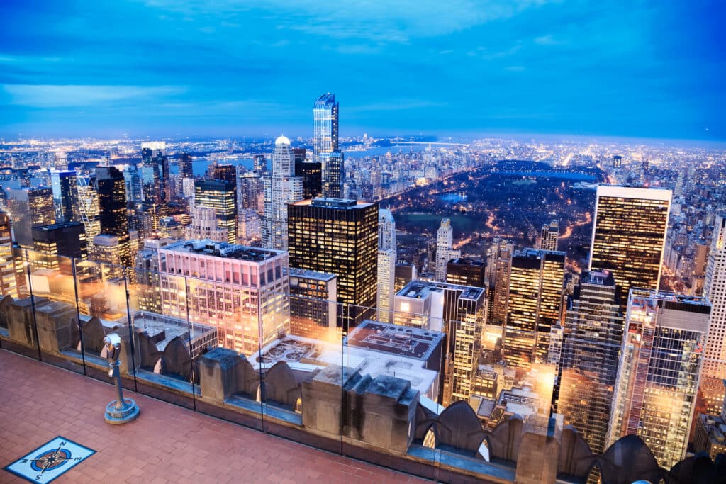 New York City, USA - January 13, 2014: View of Upper Manhattan, Central Park, Upper-deck with binoculars at observatory on Top of the Rock.